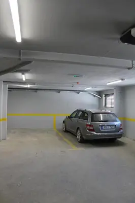 a silver car parked in a parking garage at VIP 2 Apartment in Visoko
