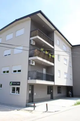 an apartment building with balconies and plants on it at VIP 2 Apartment in Visoko