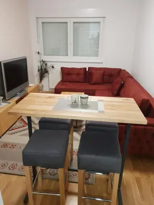 a living room with a table and a couch at VIP 2 Apartment in Visoko