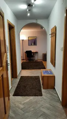 a hallway with a living room with a table at Apartment Aurelio in Zenica
