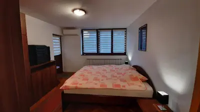 a small bedroom with a bed and a window at Apartment Aurelio in Zenica