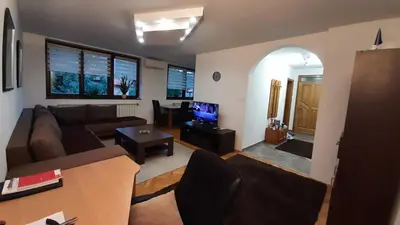 a living room with a couch and a tv at Apartment Aurelio in Zenica