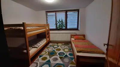 a small room with bunk beds and a window at Apartment Aurelio in Zenica