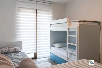a bedroom with two bunk beds and a bed at Apartman Anđela in Kupres