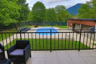 a black fence with a swimming pool in a yard at Villa Lena in Bihać
