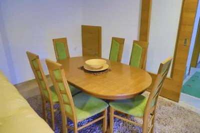 a dining room table with chairs and a bowl on it at Villa Lena in Bihać