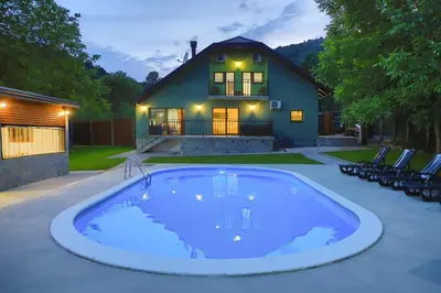 a swimming pool in front of a house at Villa Lena in Bihać