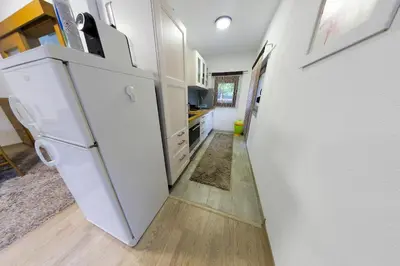 a kitchen with a white refrigerator in a room at Villa Lena in Bihać