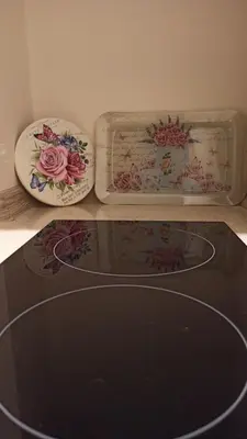 two plates and a glass tray with roses on it at Apartmani President III in Banja Luka