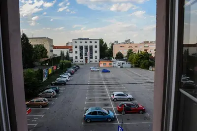 a view from a window of a parking lot with cars at Apartmani President III in Banja Luka