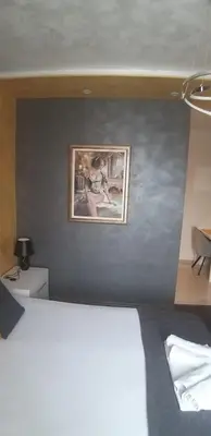 a bedroom with a painting on the wall at Apartmani President III in Banja Luka