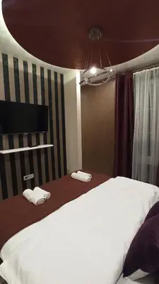 a bedroom with a bed and two towels on the floor at Apartmani President IV in Banja Luka