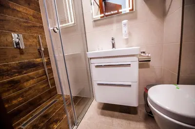 a bathroom with a shower and a sink and a toilet at Zlatna Kruna in Banja Luka