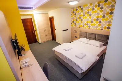 a hotel room with a bed and a television at Zlatna Kruna in Banja Luka