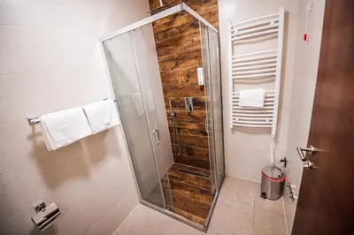 a shower with a glass door in a bathroom at Zlatna Kruna in Banja Luka