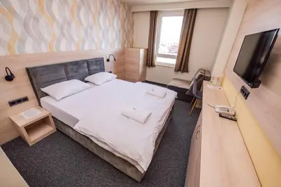 a hotel room with a bed and a television at Zlatna Kruna in Banja Luka