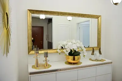 a bathroom with a mirror and a vase of flowers at Luxury Apartment Karic FREE parking in Tuzla