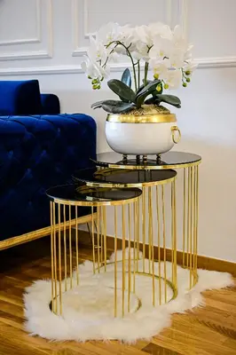 a gold and black table with a vase on it at Luxury Apartment Karic FREE parking in Tuzla