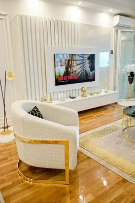 a living room with a white couch and a tv at Luxury Apartment Karic FREE parking in Tuzla