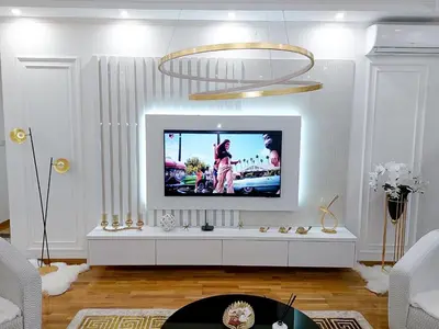 a living room with a tv on a white wall at Luxury Apartment Karic FREE parking in Tuzla