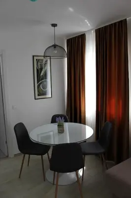 a dining room with a white table and chairs at Royal Apartmani in Banja Luka