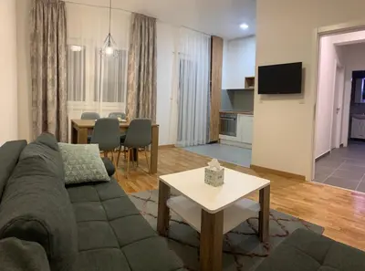a living room with a couch and a table at Apartman LUAN in Banja Luka