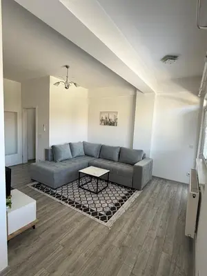 a living room with a couch and a table at Apartman San in Bugojno