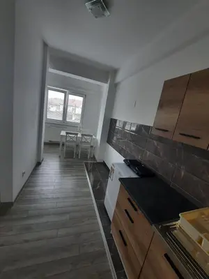 a kitchen with wooden floors and a counter top at Apartman San in Bugojno
