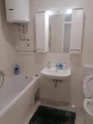 a bathroom with a sink and a tub and a toilet at Apartman Merkator in Banja Luka