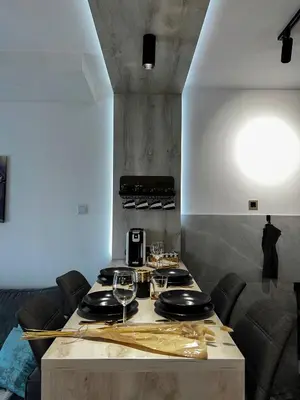 a kitchen with a table with wine glasses on it at Emma Park Lake Emma Parklake in Tuzla