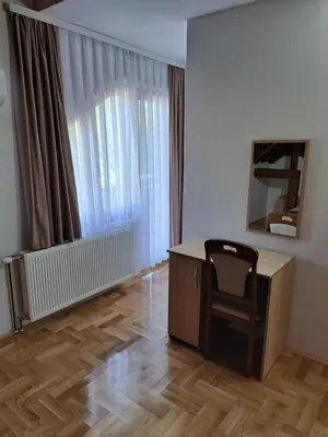 a office with a desk and a chair in a room at Apartman Bubic in Banja Vrućica