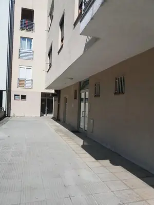 an empty sidewalk in front of a building at Stan na dan Centar Banja Luka in Banja Luka