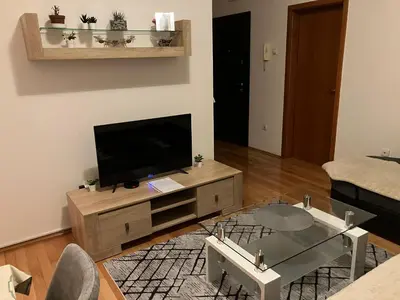a living room with a flat screen tv on a wooden entertainment center at Stan na dan Centar Banja Luka in Banja Luka