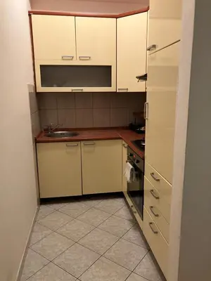 a small kitchen with white cabinets and a sink at Stan na dan Centar Banja Luka in Banja Luka