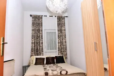 a small room with a bed in front of a window at Apartman centar blizina Kastela i Splava in Banja Luka