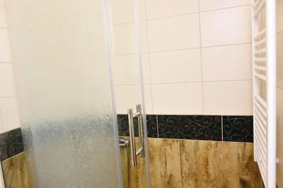 a shower with a glass door in a bathroom at Apartman centar blizina Kastela i Splava in Banja Luka