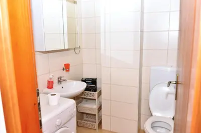 a bathroom with a toilet and a sink at Apartman centar blizina Kastela i Splava in Banja Luka