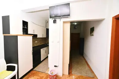 a kitchen with a tv on a wall at Apartman centar blizina Kastela i Splava in Banja Luka