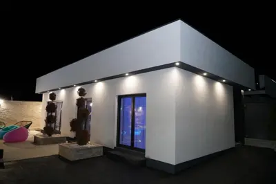 a white building with lights on it at night at Villa Vidovic Banja Luka in Banja Luka