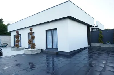 a white house with a black roof at Villa Vidovic Banja Luka in Banja Luka