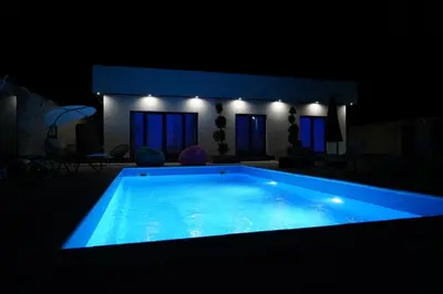 a swimming pool in a dark room with blue lighting at Villa Vidovic Banja Luka in Banja Luka