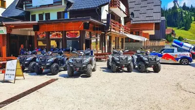 a group of four atvs parked in front of a building at Hotel Villa Ugar Vlašić in Vlasic