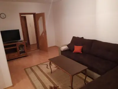 a living room with a couch and a tv at Apartman Laura in Kupres