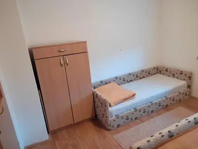 a small room with a chair and a cabinet at Apartman Laura in Kupres