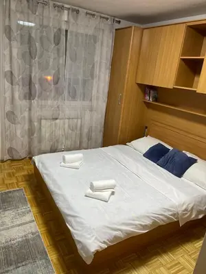 a bedroom with a bed with two towels on it at Apartment Host in Tuzla