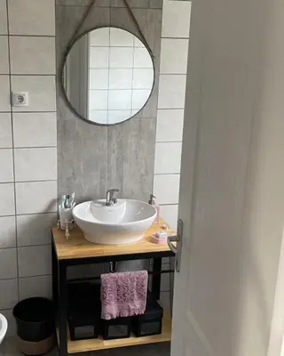 a bathroom with a sink and a mirror at Bajka na dan two bedroom apartment in Bosanska Gradiška