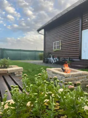 a backyard with a fire pit and a building at Bajka na dan two bedroom apartment in Bosanska Gradiška