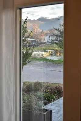 a window with a view of a road and a house at Apartment Studenac in Banja Luka
