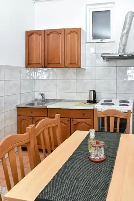 a kitchen with a wooden table with glasses on it at Apartment Studenac in Banja Luka
