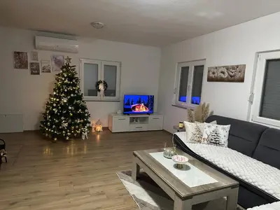 a living room with a christmas tree and a couch at Vikendica Bruše in Jaklići